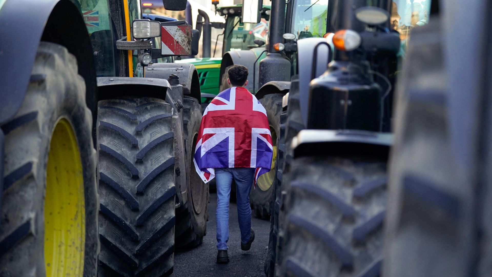 Environment secretary says 'sorry' to farmers over tax 'shock' - as noisy protest impacts speech